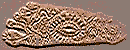 The imprint of a foot with an eye-shaped figure in the center.